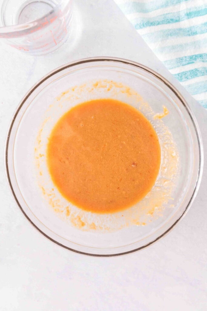 Creamy homemade peanut sauce whisked until smooth for Peanut Butter Ramen Noodles.