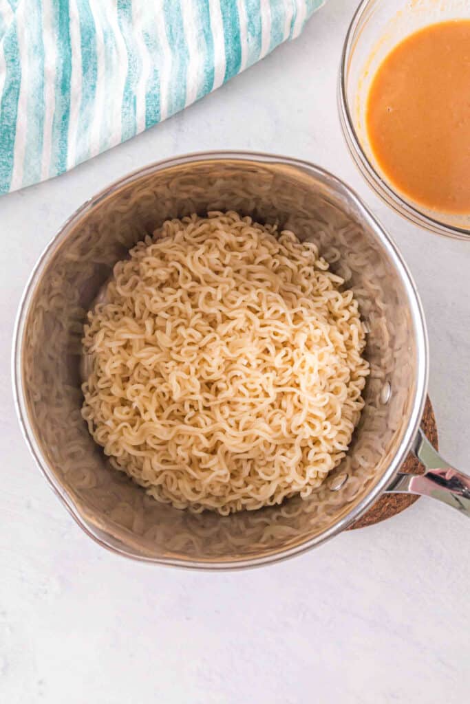 Cooked ramen noodles drained and ready to be tossed with creamy peanut sauce.