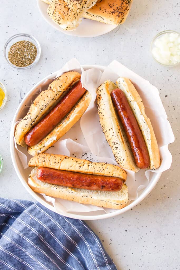 Toasted poppy seed buns filled with browned all-beef hot dogs before adding toppings