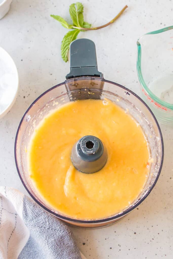Peach mixture blended until smooth for an easy frozen peach cocktail recipe.