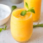 Square image of a Frozen Peach Bellini garnished with mint, perfect for recipe cards and social media.
