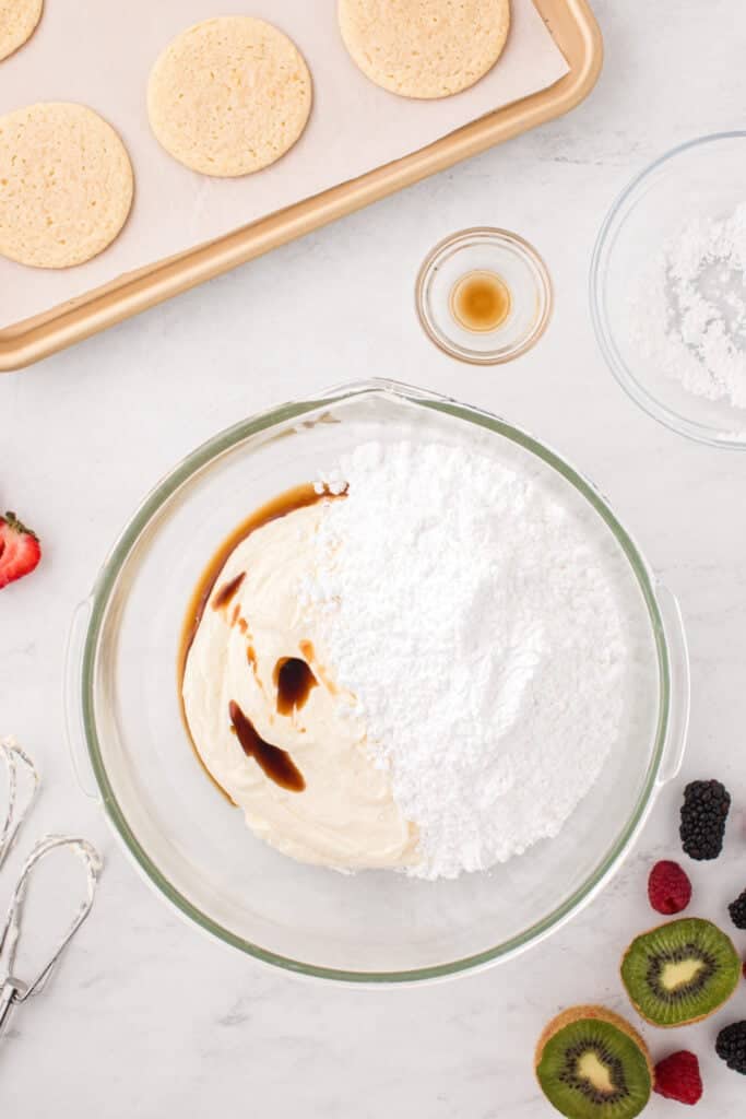 Cream cheese frosting ingredients combined in a mixing bowl.