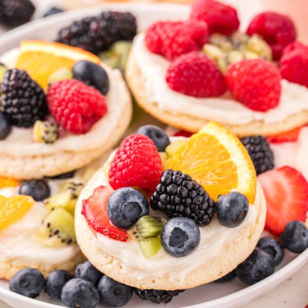 Square image of homemade Fruit Pizza Cookies with fresh berries and cream cheese frosting.