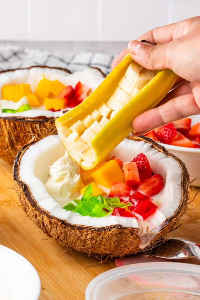 Layering fresh banana slices into Halo Halo.