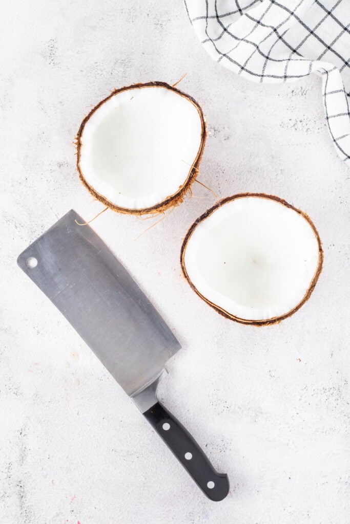 Fresh coconut cut into halves to use as serving bowls for Halo Halo.
