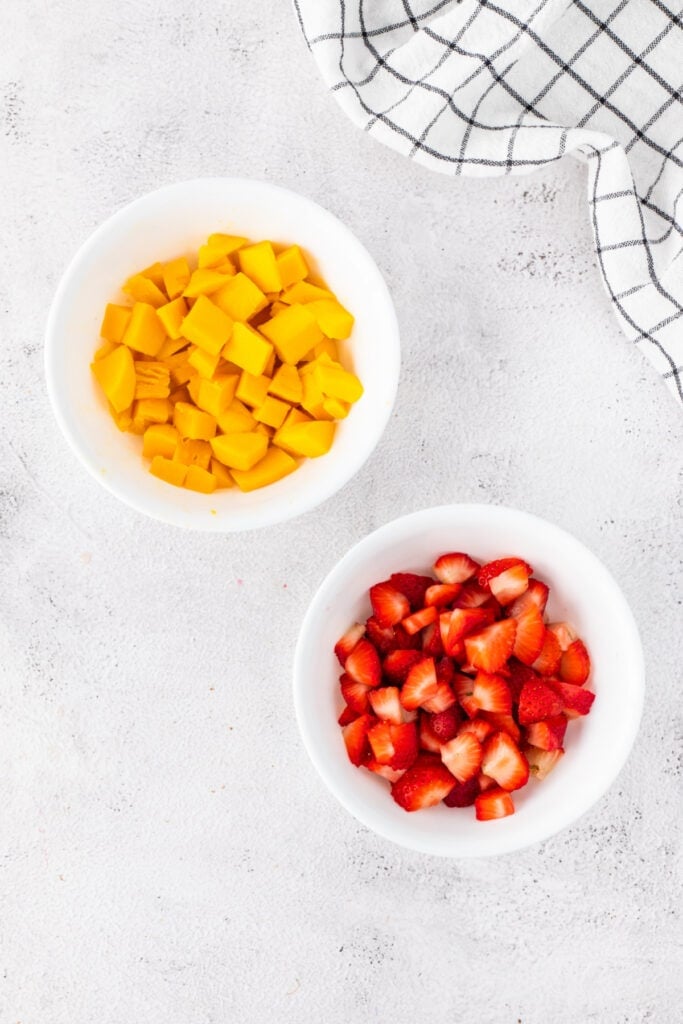 Diced mangoes and sliced strawberries prepared for Halo Halo.