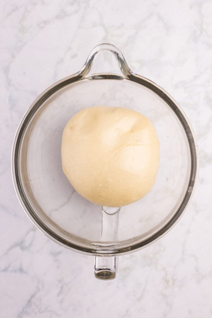 Smooth ball of homemade hamburger bun dough before the first rise