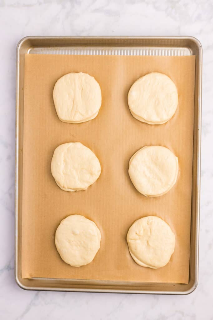 Cut homemade hamburger bun rounds before the second rise