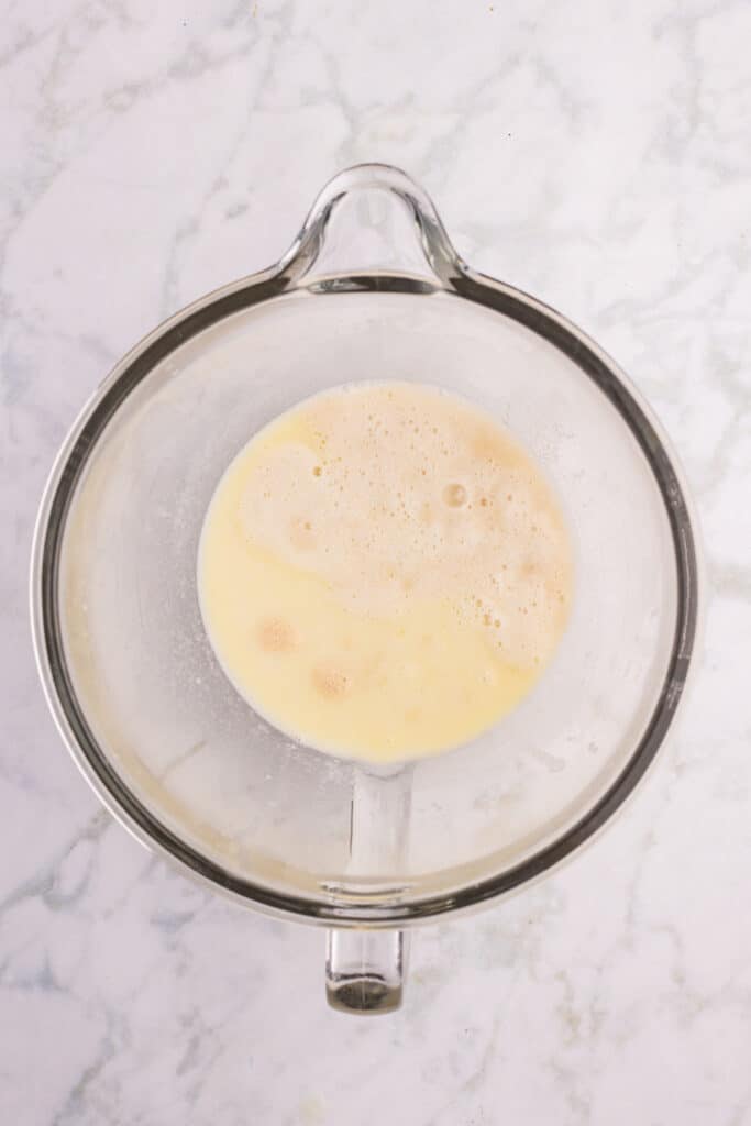 Yeast mixture added to the stand mixer bowl before mixing the dough