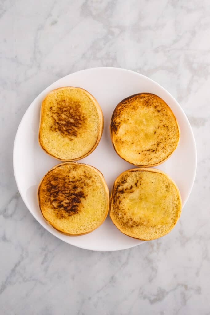 Toasted hamburger buns with golden brown interiors.