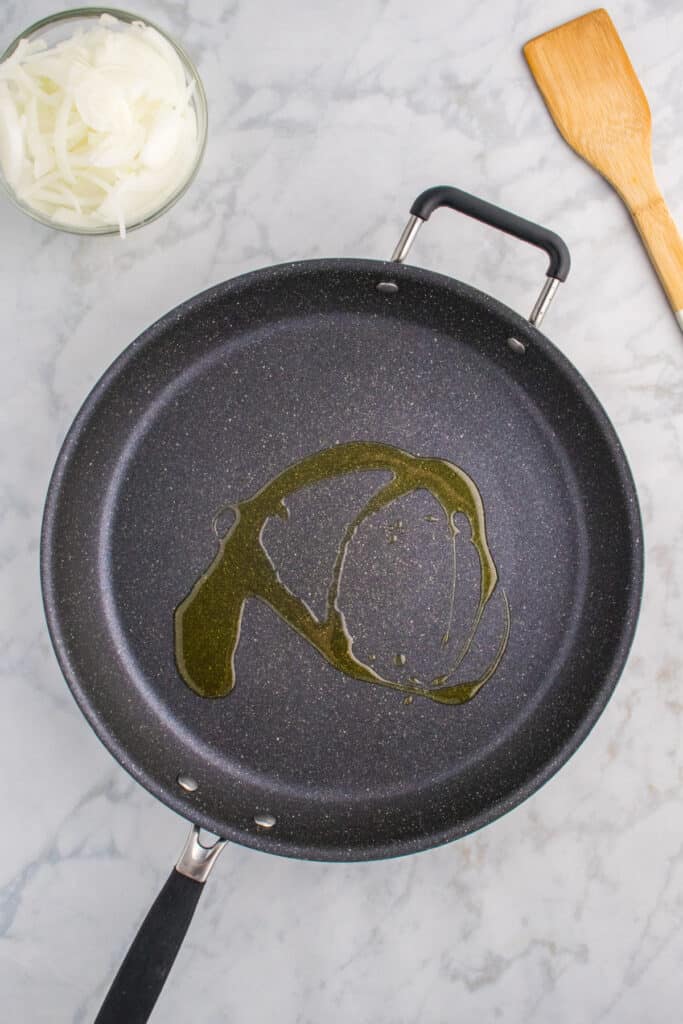 Oil heating in a large skillet for making Oklahoma Onion Burgers.