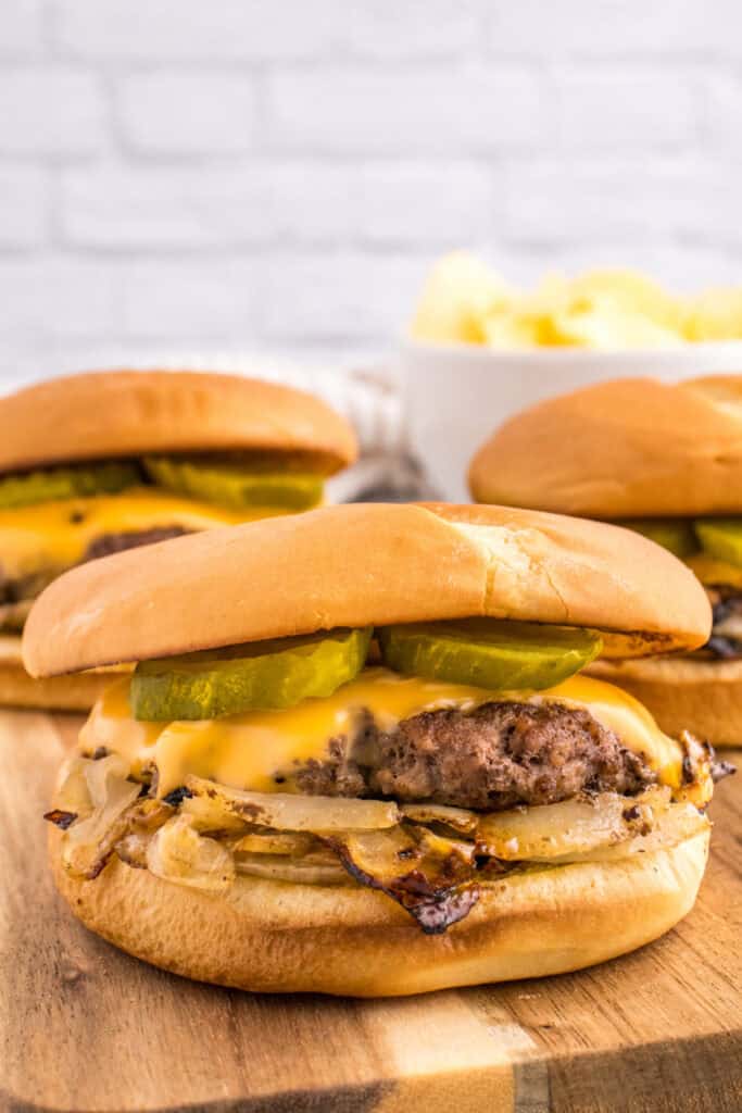 Oklahoma Onion Burger with caramelized onions, melted cheese, and pickles