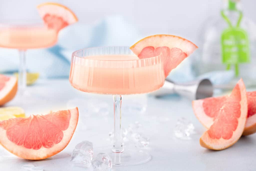 Easy Paloma Cocktail made with fresh grapefruit juice, tequila, lime, agave, and sparkling water, garnished with grapefruit slices.