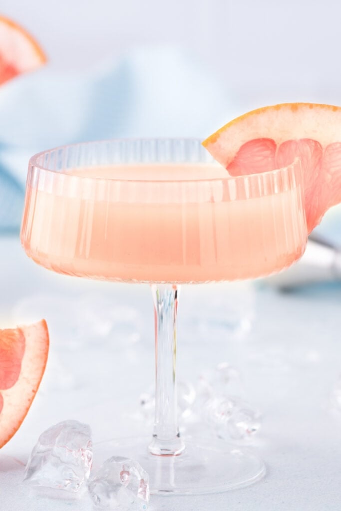 Finished Paloma Cocktail garnished with fresh grapefruit in a coupe glass.