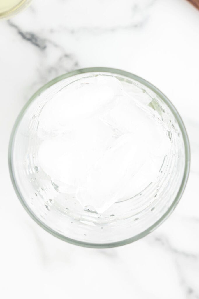 Ice added to a mixer glass for serving a spicy margarita