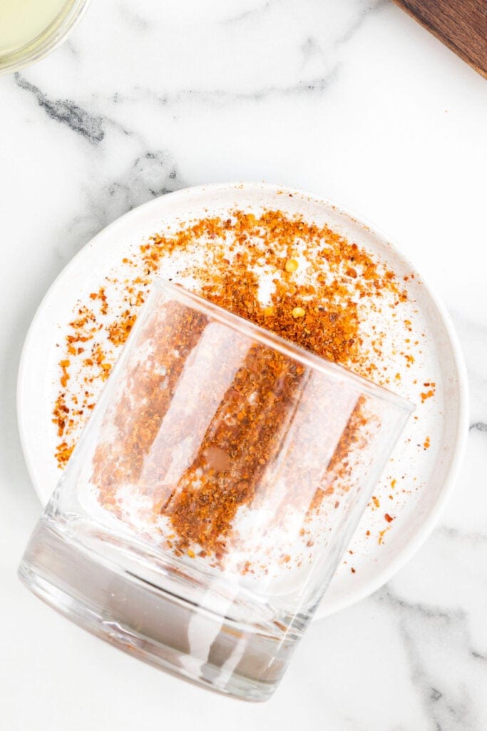 Glass coated with a Tajín rim for a spicy jalapeño margarita