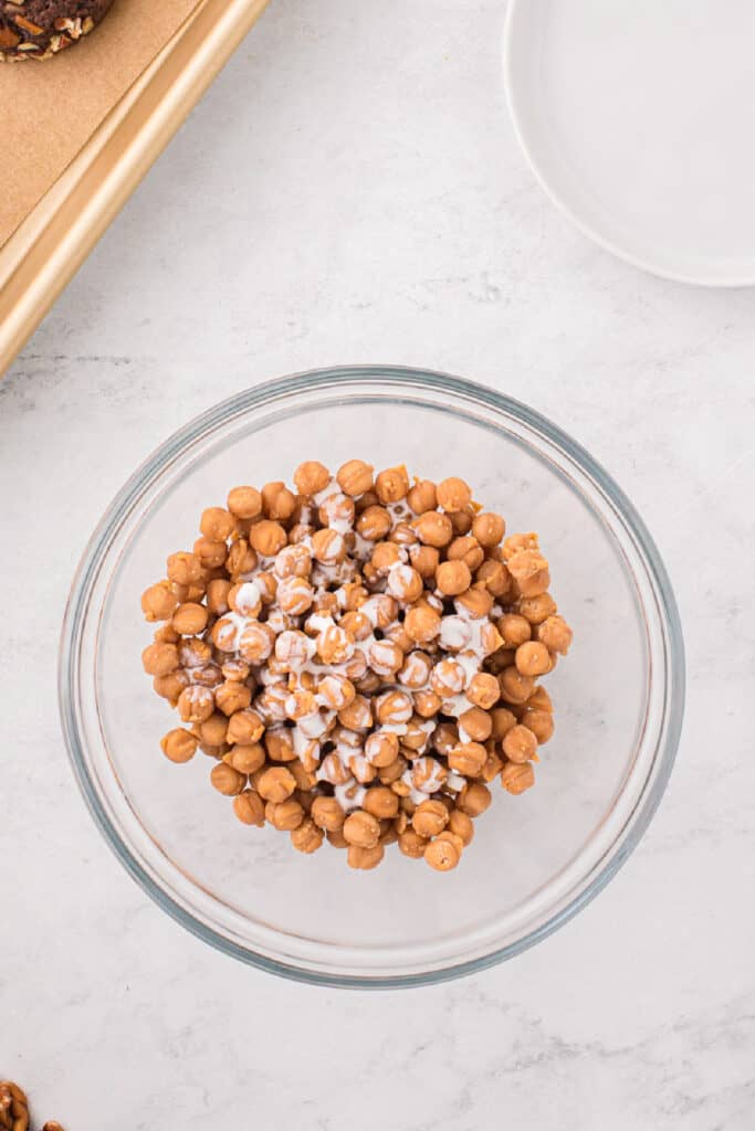 Caramel bits melted with heavy cream to make a smooth caramel drizzle for Easy Turtle Cookies.