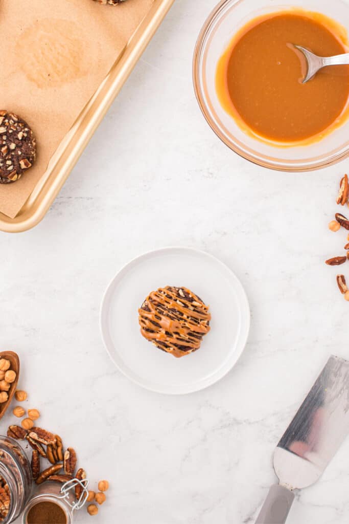 Freshly baked Easy Turtle Cookie topped with warm caramel drizzle.
