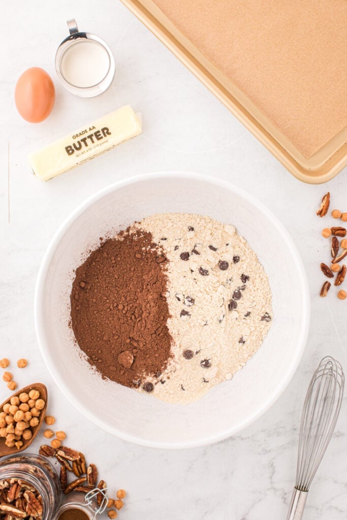 Chocolate chip cookie mix and cocoa powder in a mixing bowl before making Easy Turtle Cookies.