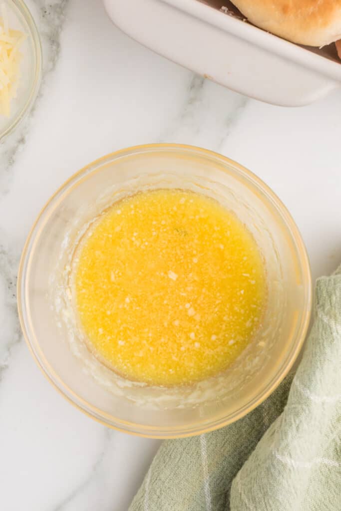 Seasoned melted butter mixture prepared for brushing over the mini bagel sliders