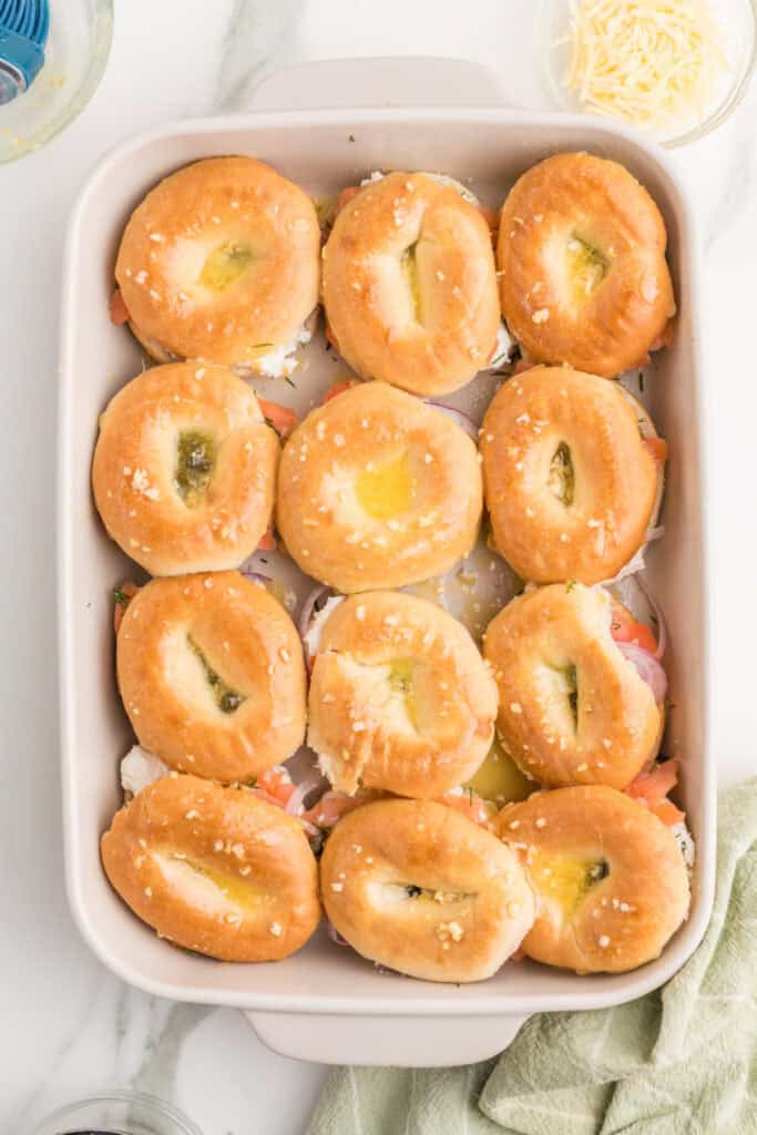 Seasoned melted butter brushed over the tops of assembled bagel and lox sliders