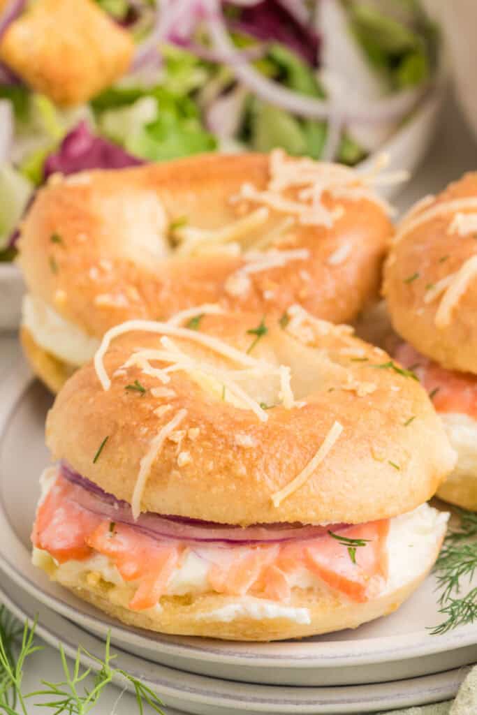 Baked Bagels & Lox Slider served on a plate with smoked salmon, cream cheese, red onion, and dill