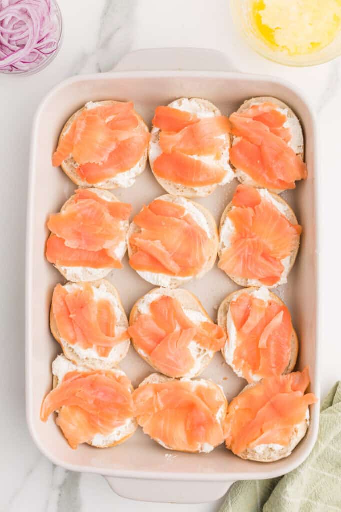 Smoked salmon layered over cream cheese on mini bagel bottoms