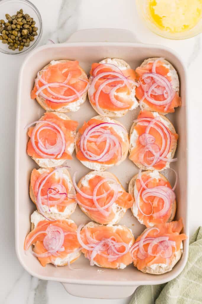 Thinly sliced red onion added over smoked salmon and cream cheese on mini bagels