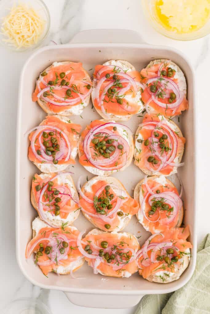 Fresh dill sprinkled over smoked salmon, capers, and red onion on mini bagels