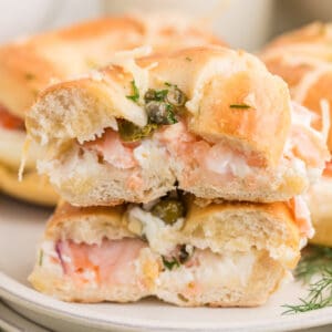 Baked Bagels & Lox Sliders stacked with smoked salmon, cream cheese, red onion, capers, and fresh dill