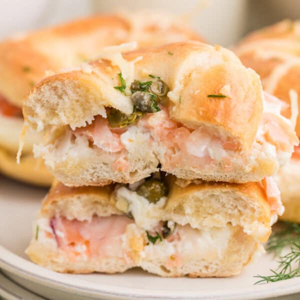 Baked Bagels & Lox Sliders stacked with smoked salmon, cream cheese, red onion, capers, and fresh dill