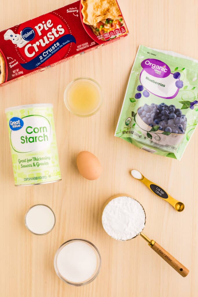 Ingredients for homemade Blueberry Pop-Tarts arranged on a light wood surface