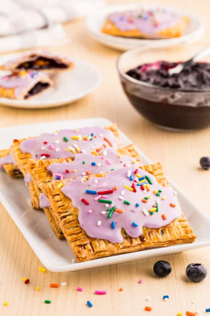 Homemade Blueberry Pop-Tarts with flaky golden crust, blueberry glaze, and colorful sprinkles