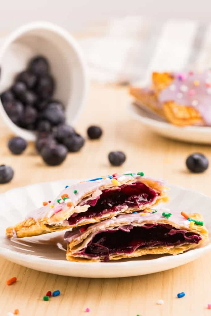 Blueberry Pop-Tarts cut open to show thick homemade blueberry filling inside flaky pie crust