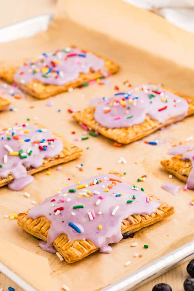 Homemade Blueberry Pop-Tarts topped with blueberry glaze and colorful sprinkles