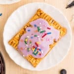 Homemade blueberry Pop-Tart topped with purple blueberry glaze and colorful sprinkles