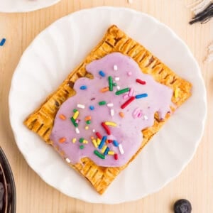 Homemade blueberry Pop-Tart topped with purple blueberry glaze and colorful sprinkles
