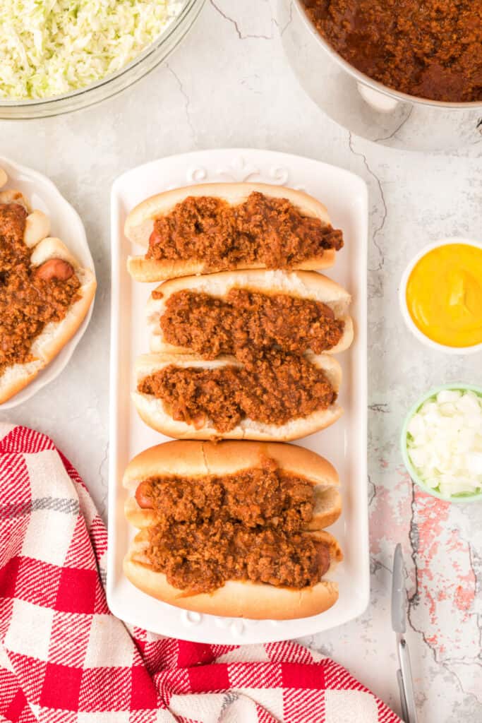 Carolina hot dogs topped with homemade hot dog chili before adding mustard, slaw, and onions.