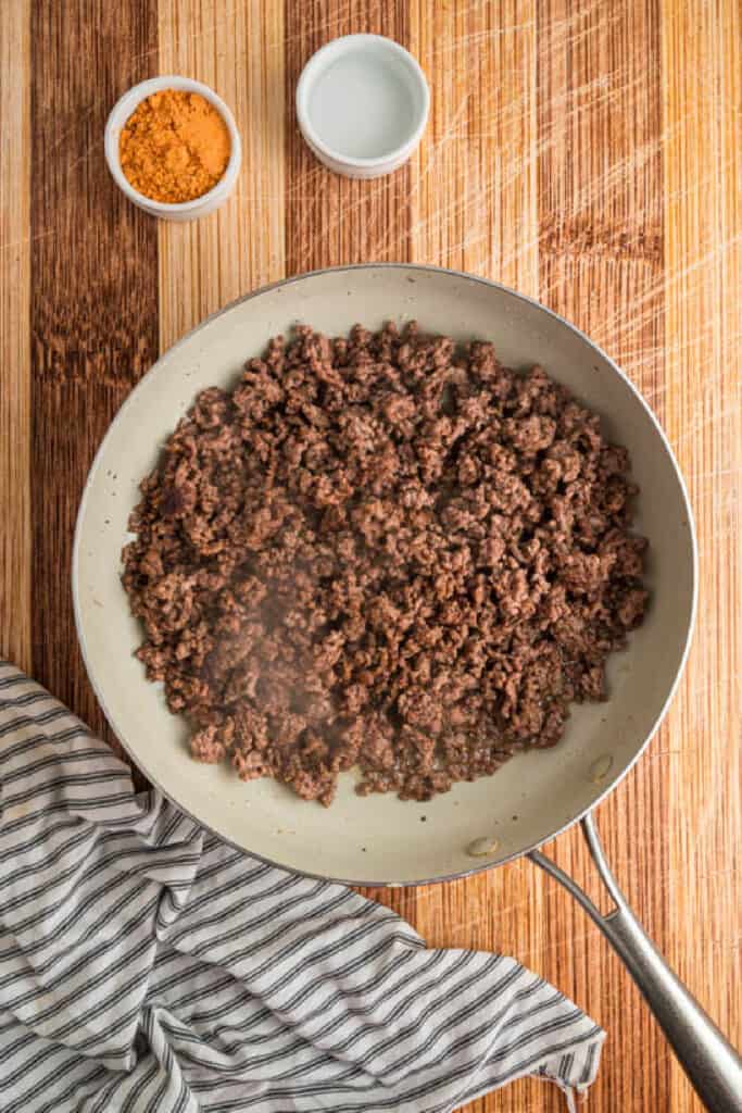 Ground beef browning in a skillet for Crunchwrap Supreme