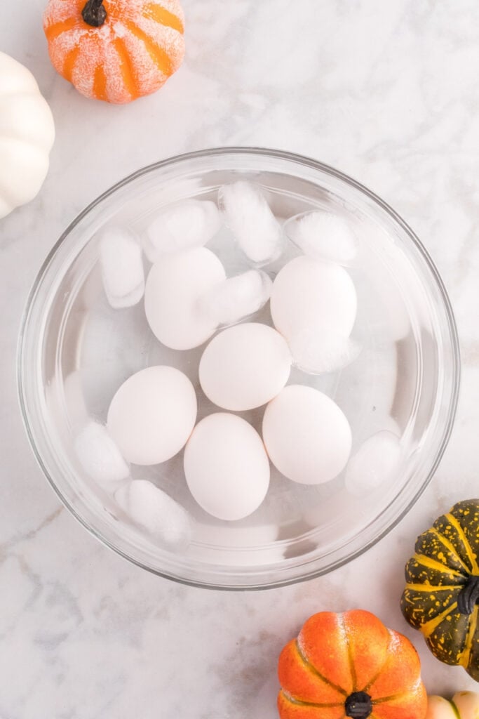 Hard-boiled eggs cooling in an ice water bath before making deviled eggs.