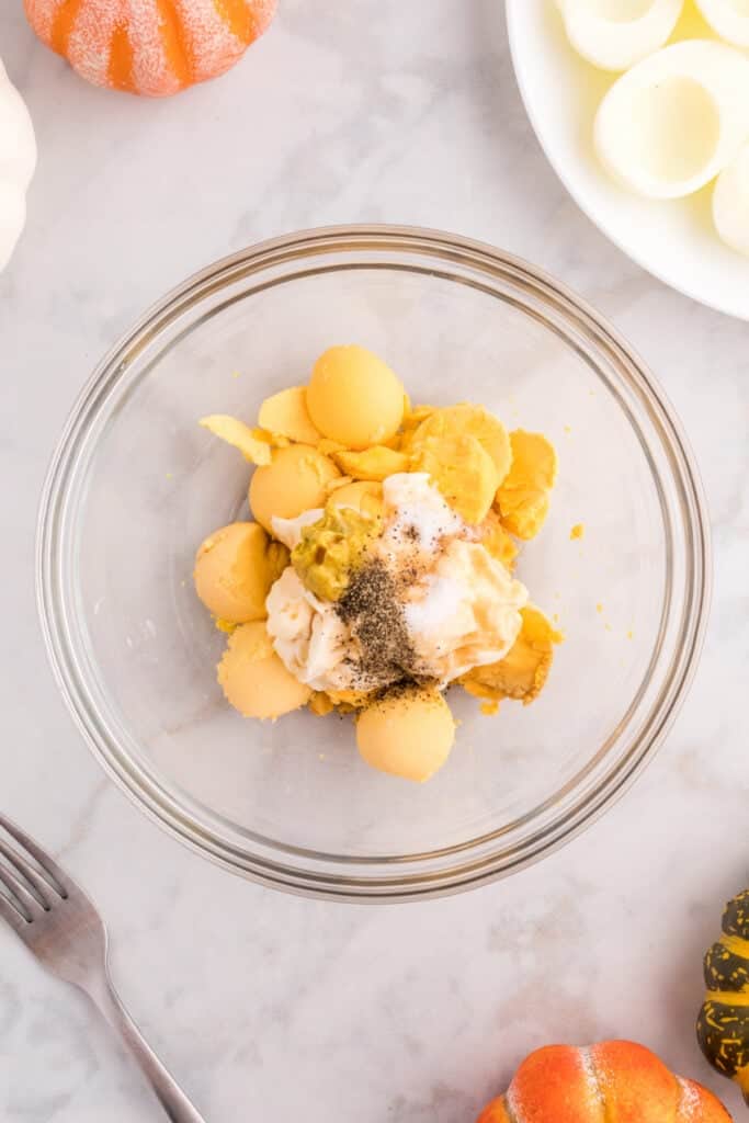 Cooked egg yolks combined with mayonnaise, spicy brown mustard, seasonings, and Worcestershire sauce for creamy deviled egg filling.