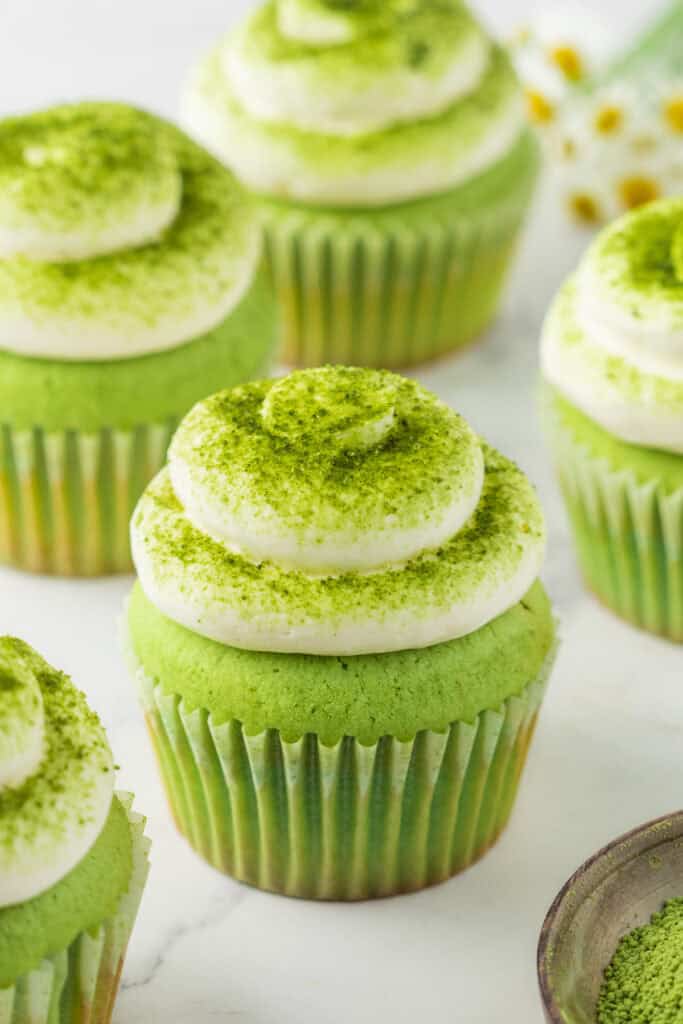 Matcha Cupcakes topped with piped vanilla buttercream and a dusting of matcha powder