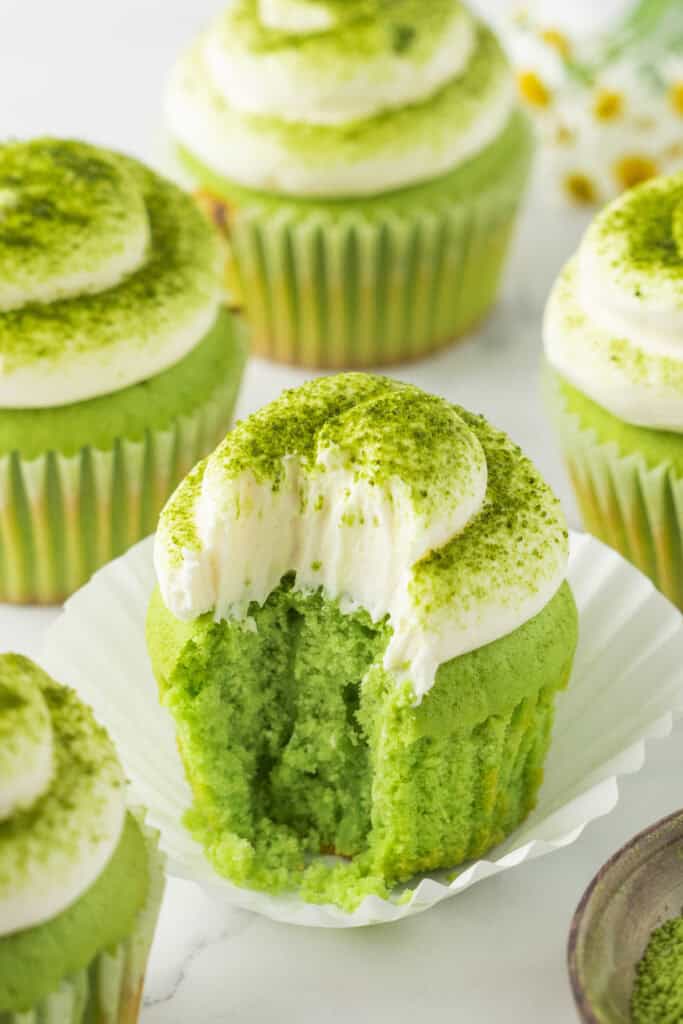 Homemade Matcha Cupcakes with vanilla buttercream, matcha powder, and small white flowers
