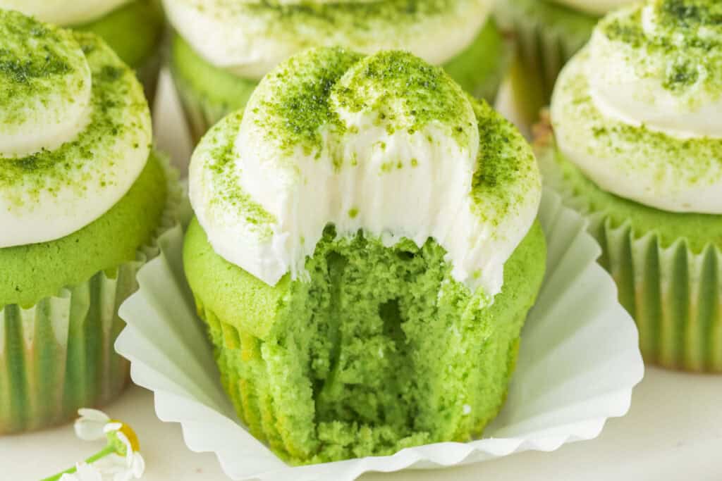 Matcha Cupcake cut open to show the soft green crumb beneath vanilla buttercream