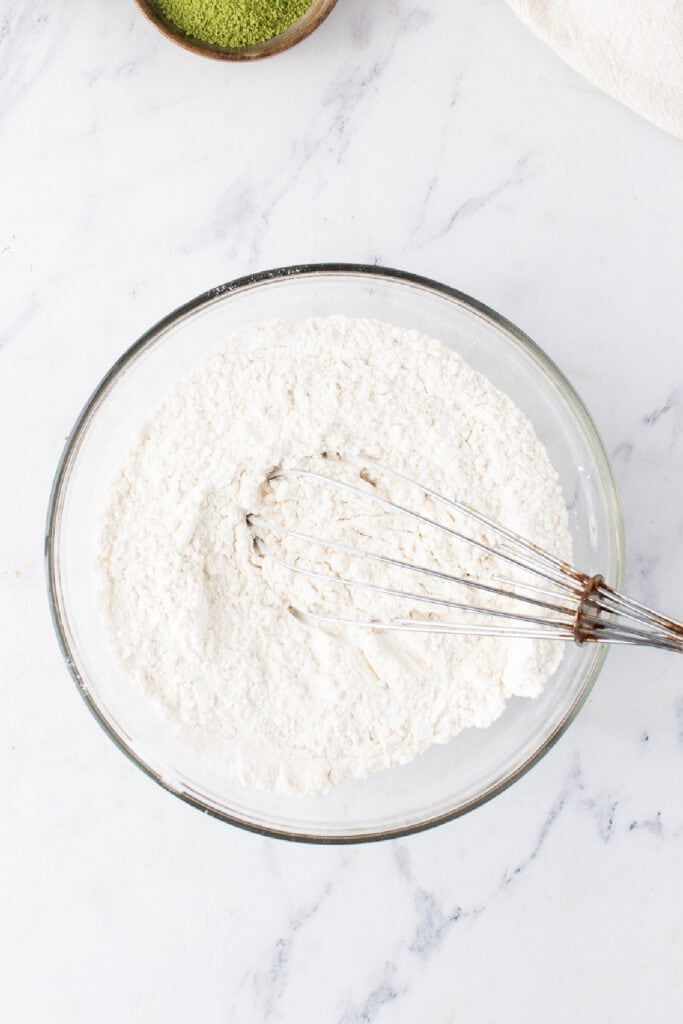 All-purpose flour, baking powder, and salt being whisked together for Matcha Cupcakes