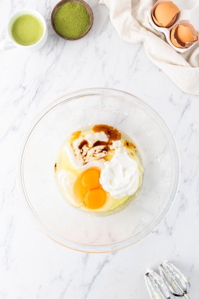 Eggs, sour cream, and vanilla extract added to the butter and sugar mixture