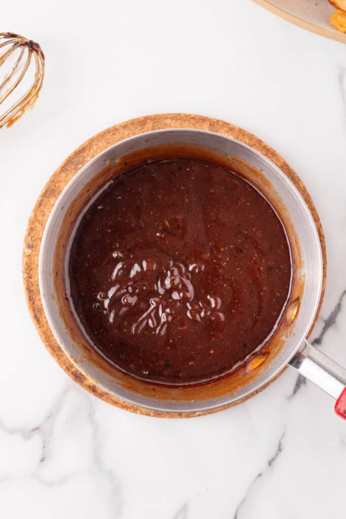 Sweet and spicy BBQ ranch sauce simmering in a saucepan