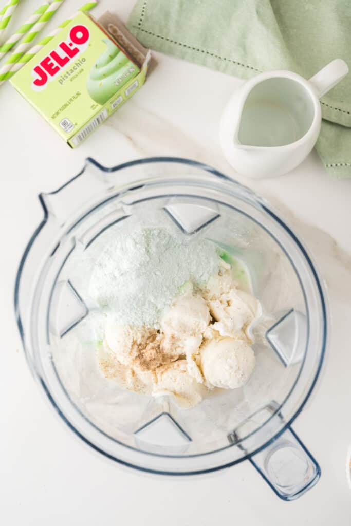 Vanilla ice cream, pistachio pudding mix, milk, and cardamom added to a blender