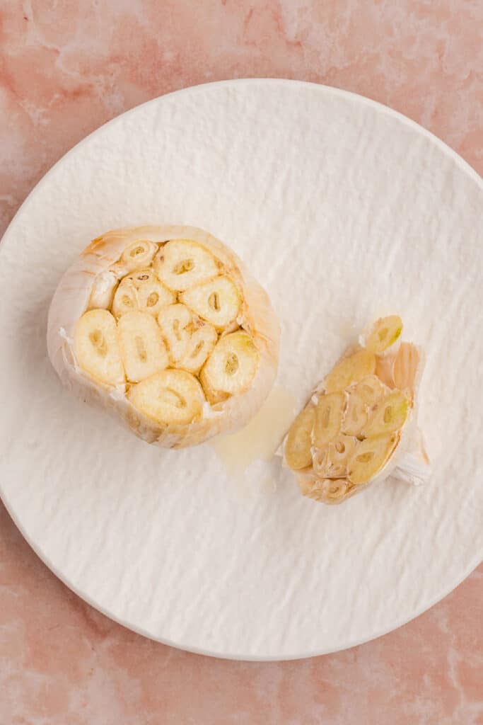Cut garlic bulb drizzled with olive oil and sprinkled with salt before roasting