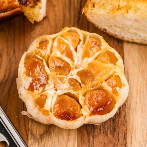 Roasted garlic with soft golden caramelized cloves served with toasted garlic bread